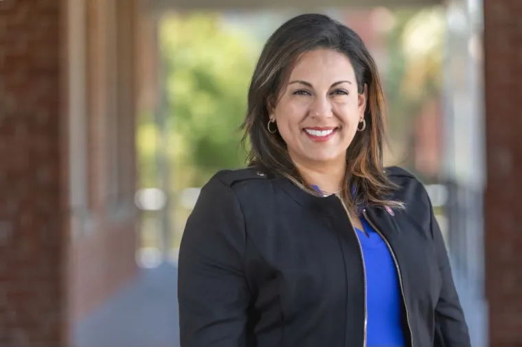 A photo of Renee Marquez in front of the Old Main Building 